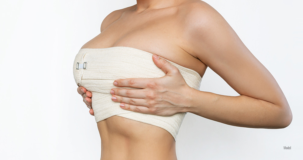 Female breast covered in bandage after Breast Lift surgery 